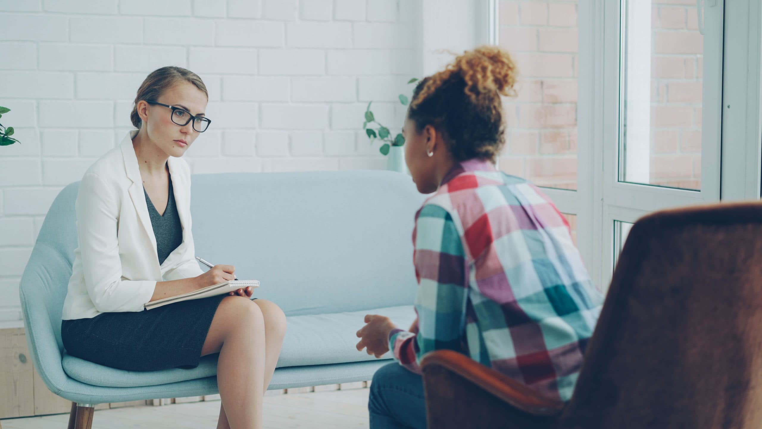 Counselor talking with a client in an office