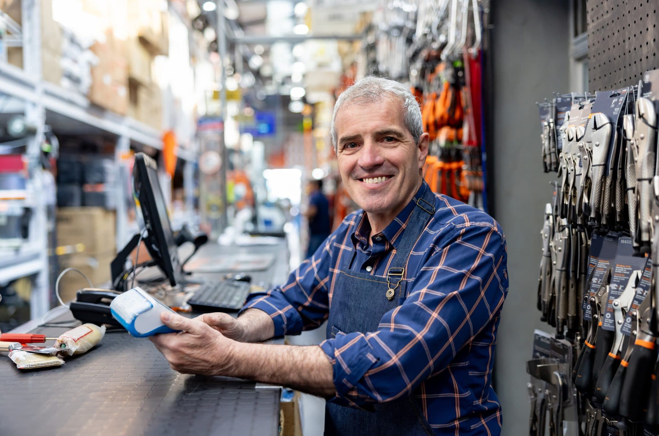 Smiling hardware store clerk at the register