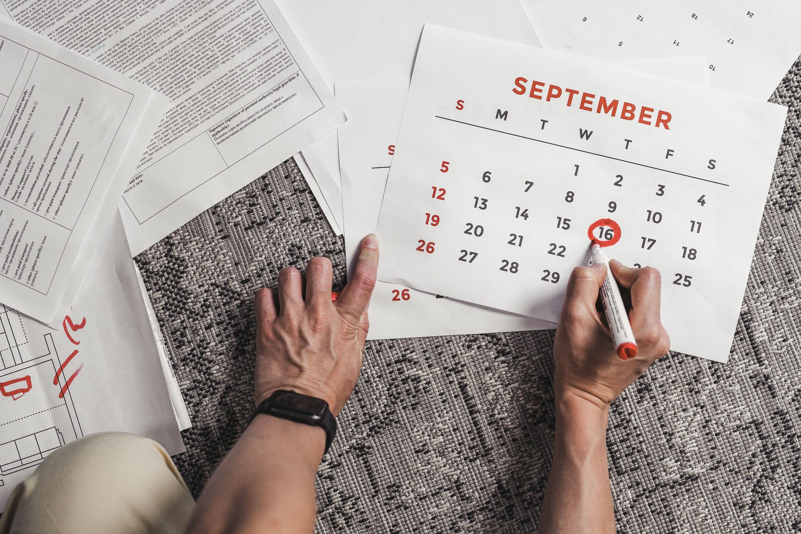 Person circling a date on a calendar