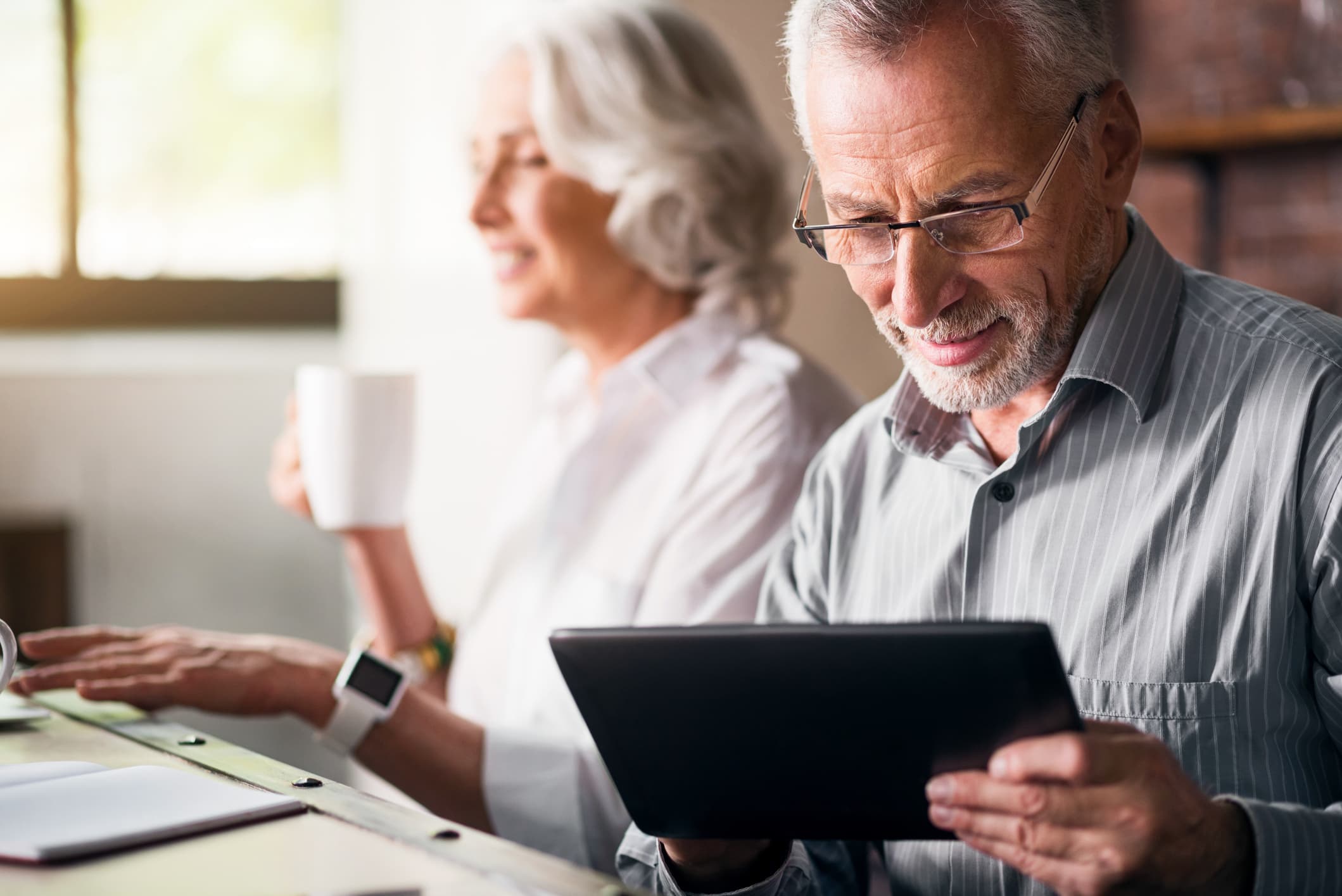 An elderly couple together at the kitchen stock photo