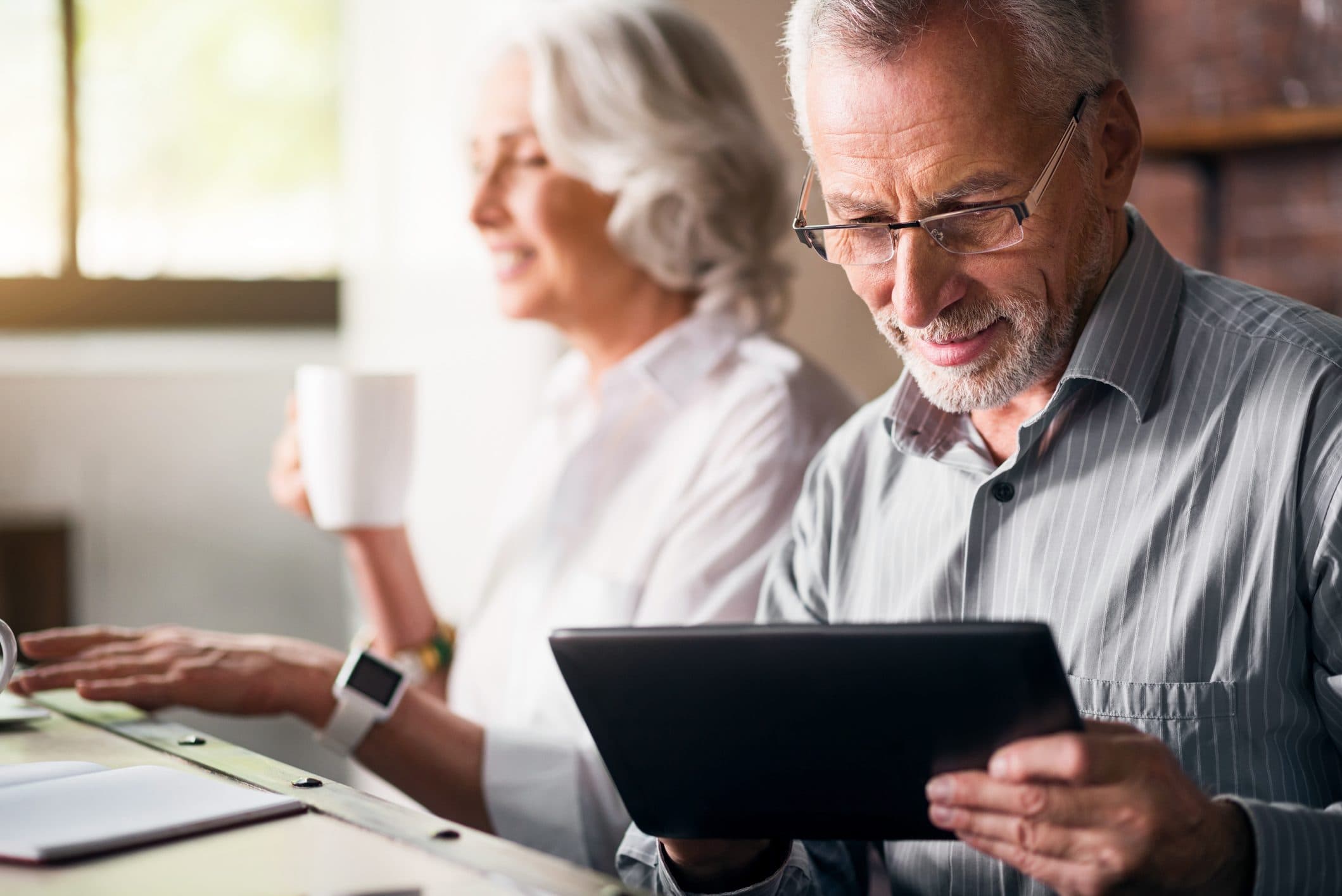 Older couple using a tablet together at home