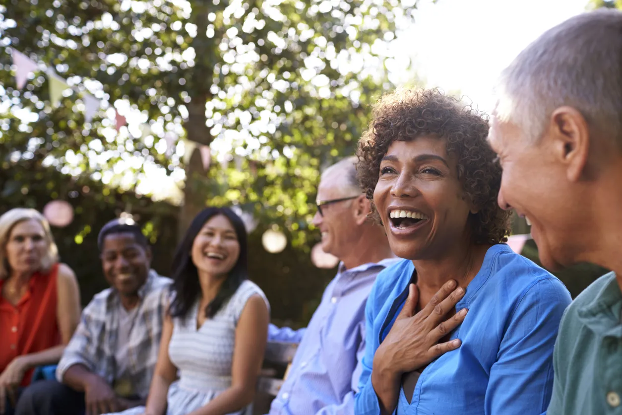Group of people sitting and smiling - one people seems happy surprised!