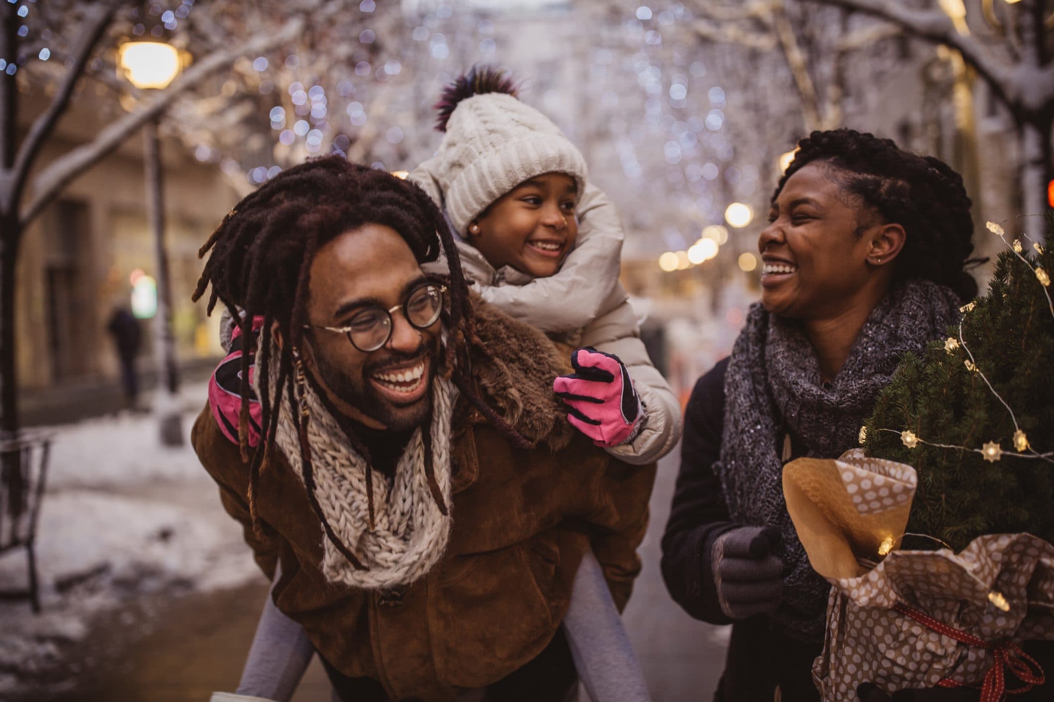 Family laughing together on a winter evening walk