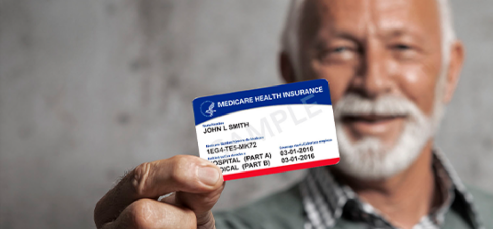 Old man holding his Medicare identification card