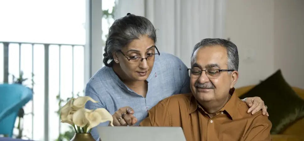 Older couple at desk with laptop