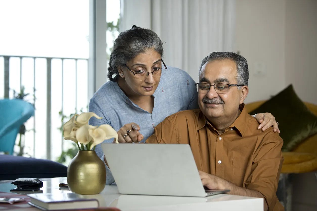 Older couple at desk with laptop
