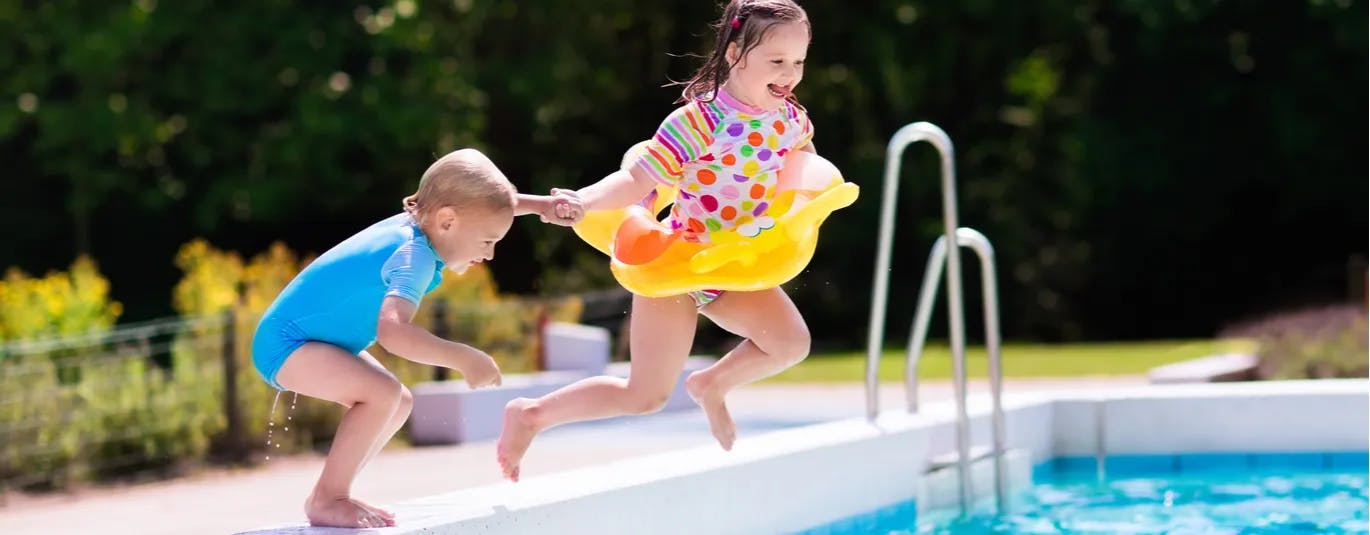 Kids jumping into a pool