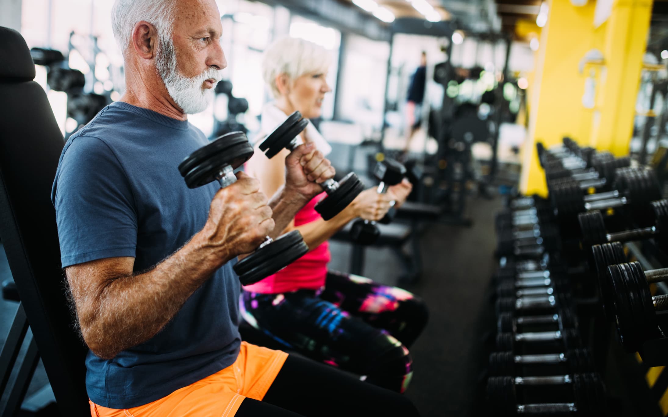 Vital mature couple exercising in the gym. stock photo