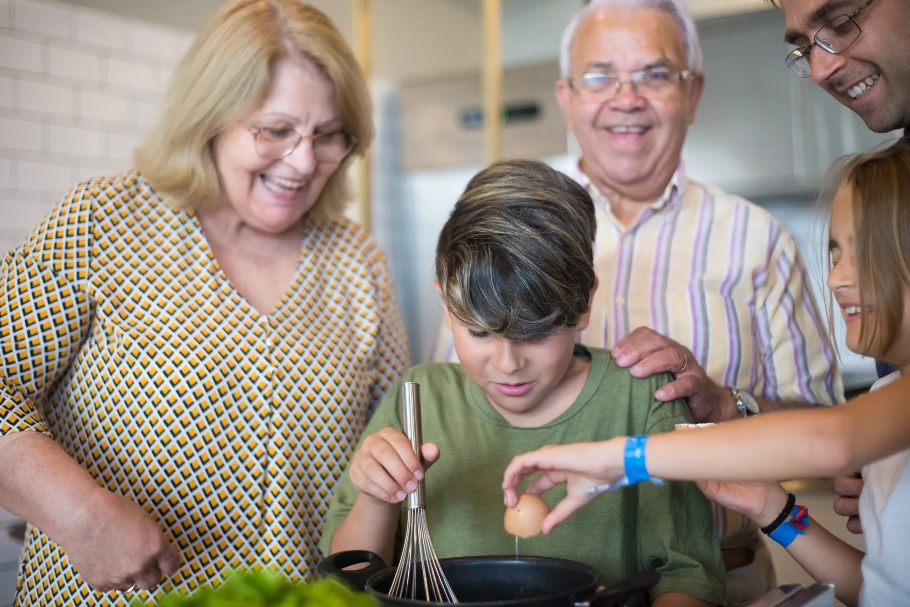 Kids cooking with adults watching