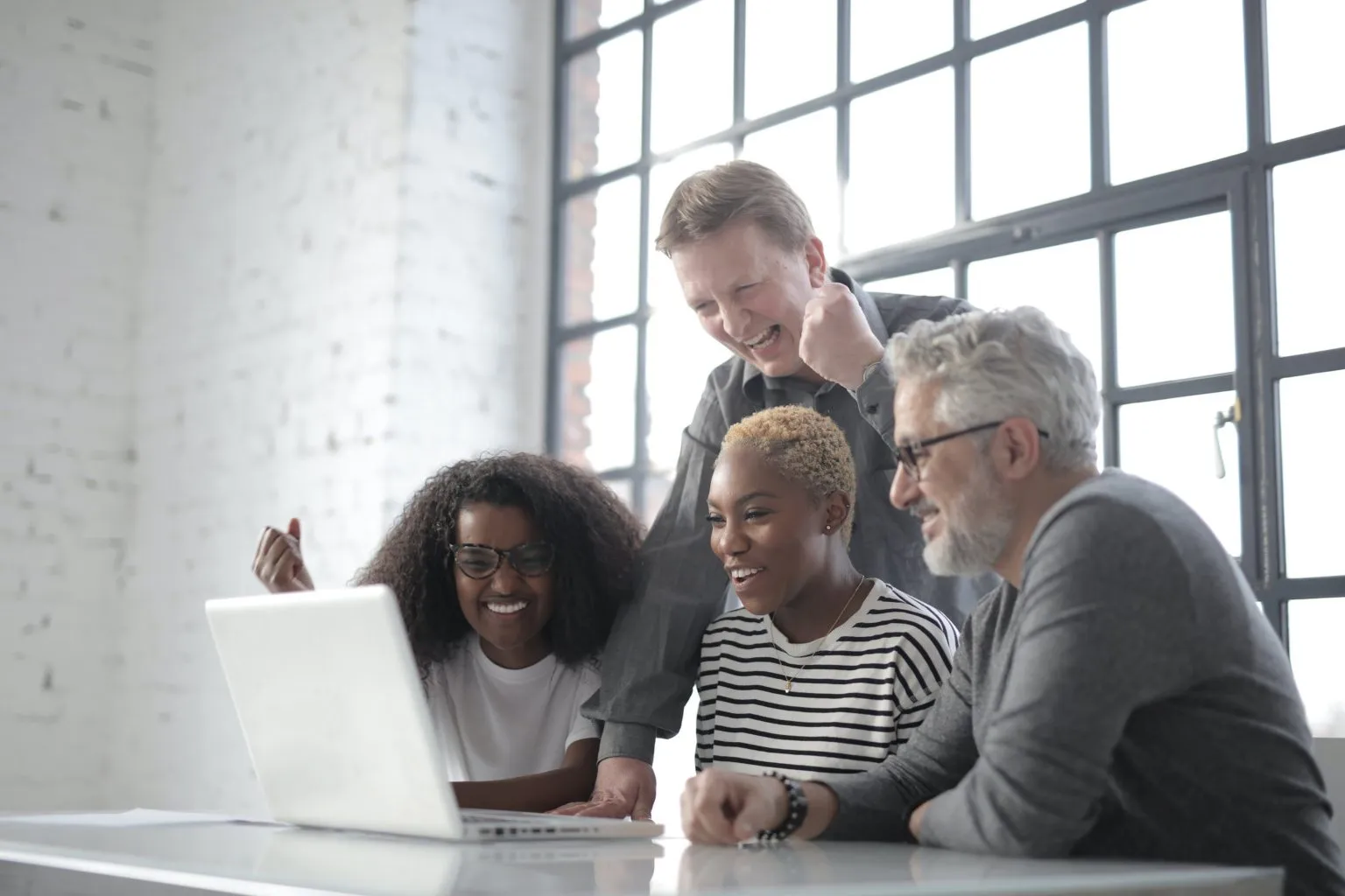 People smiling at a laptop