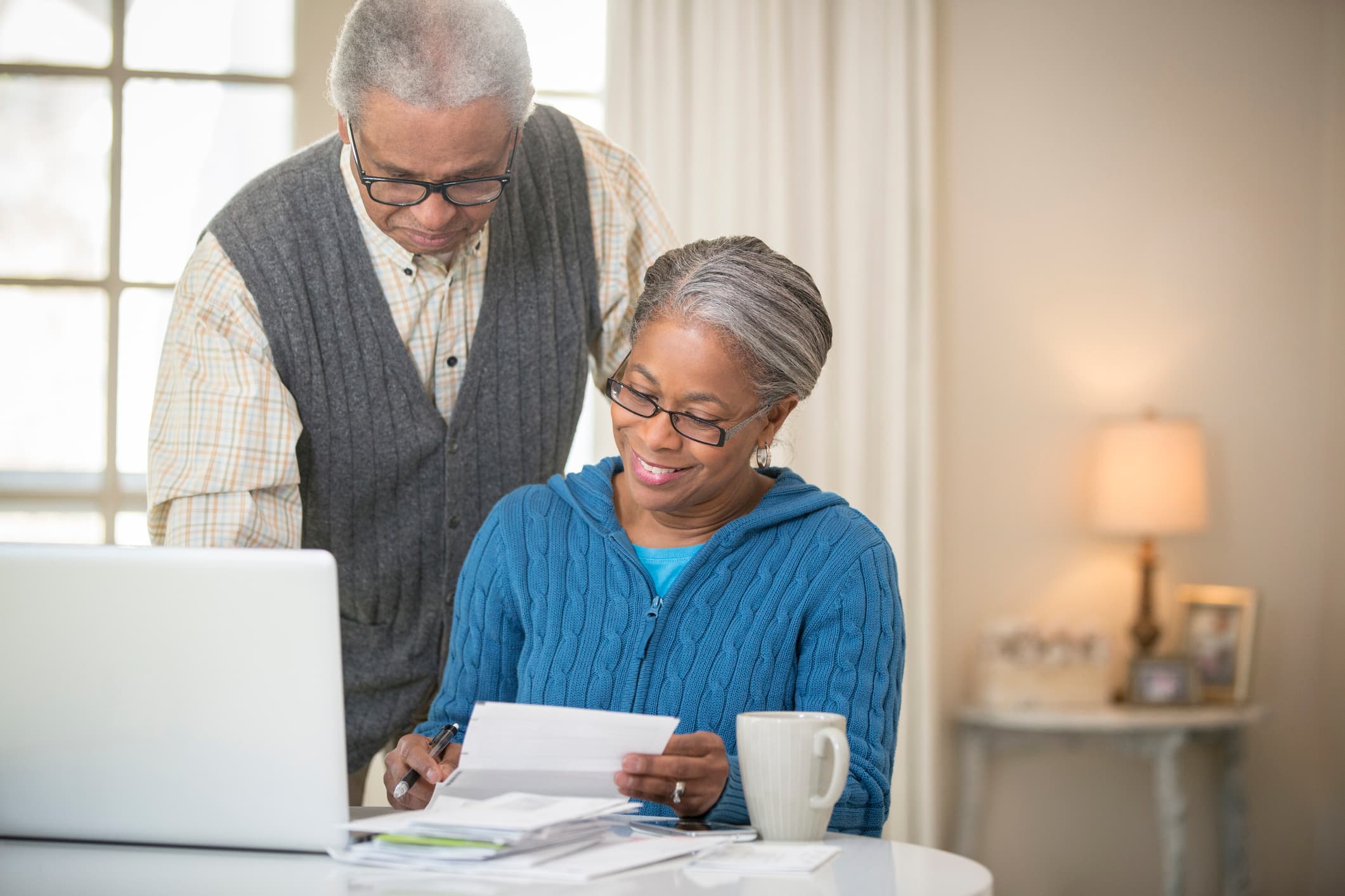 Senior couple holding papers