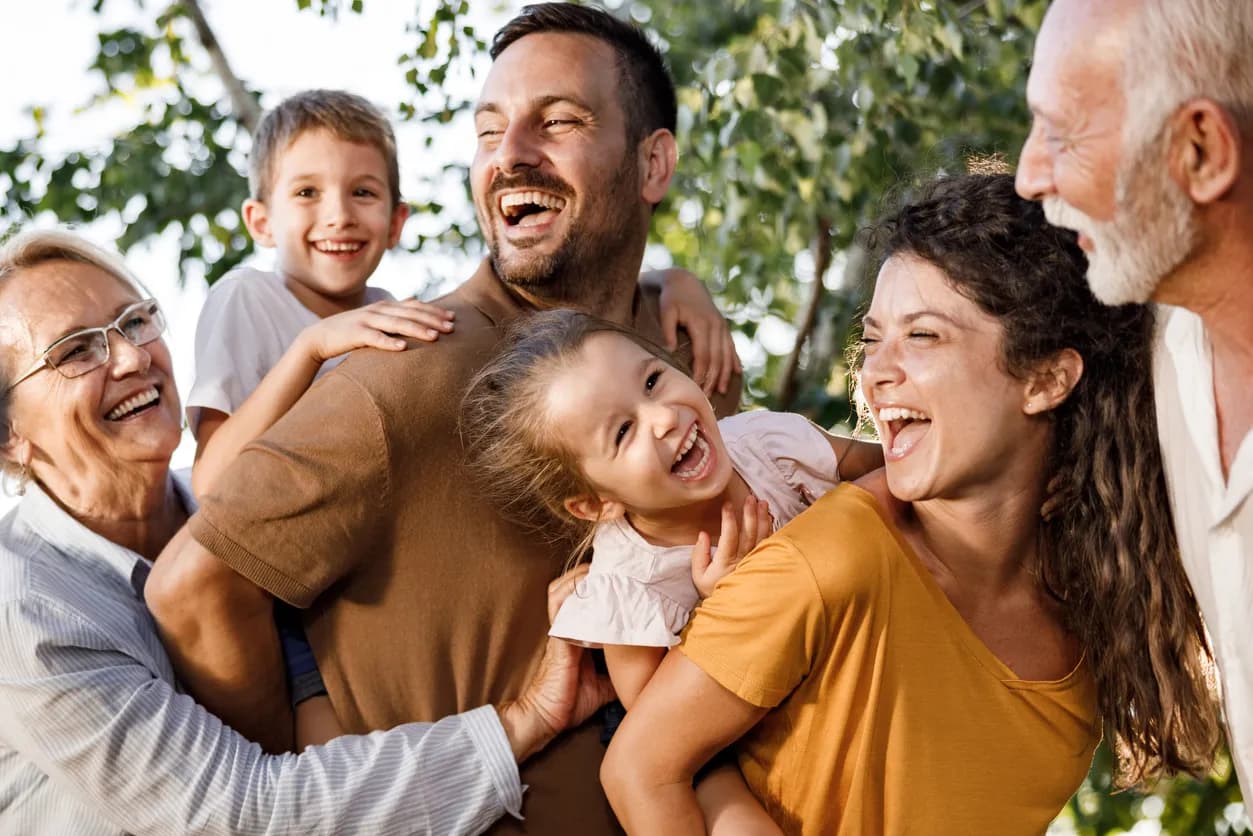 Family with kids and grandparents laughing together