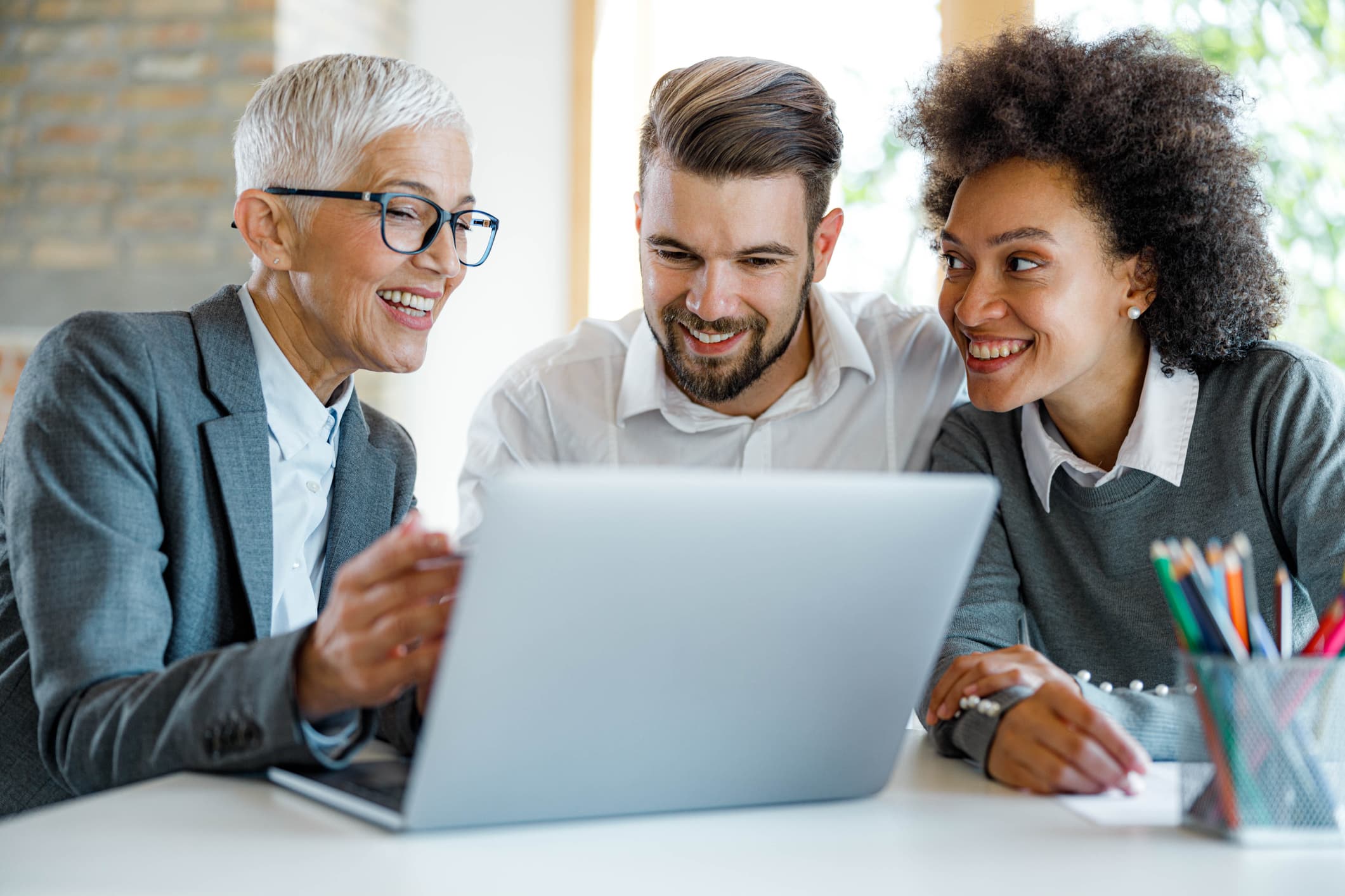 Insurance agent and young couple using computer in the office