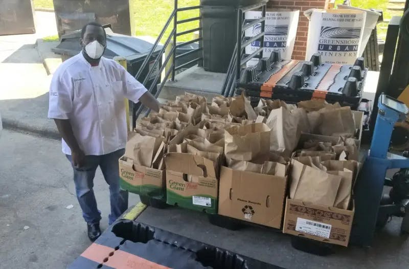 Chef with bags of food