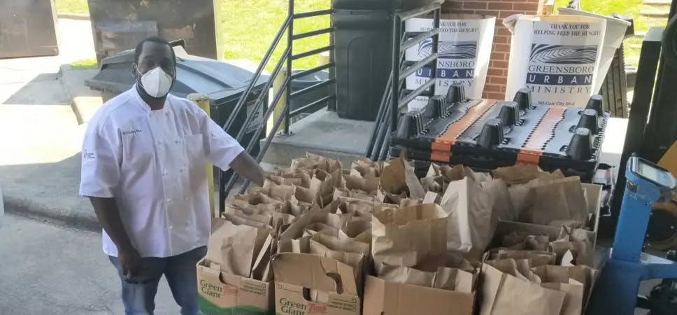 Chef with bags of food