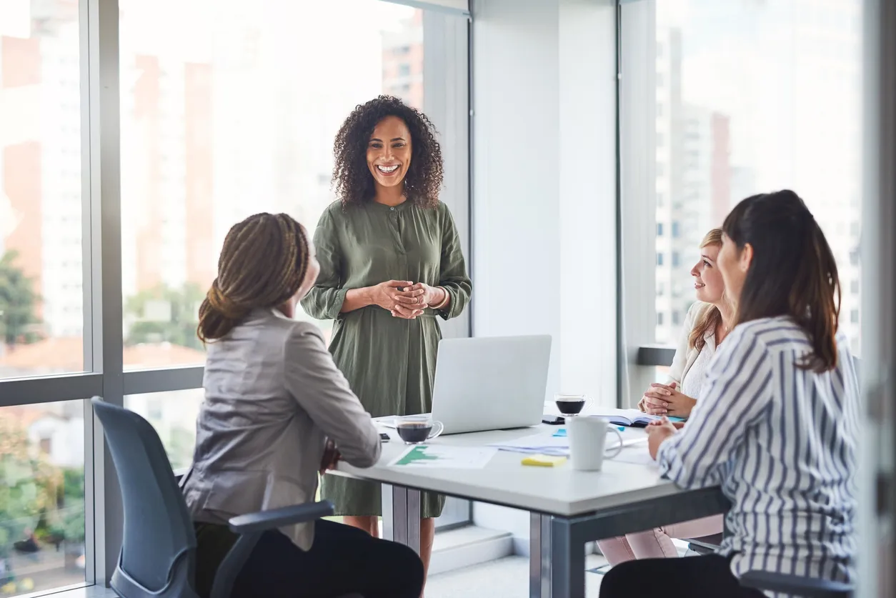 Four women at an office meeting