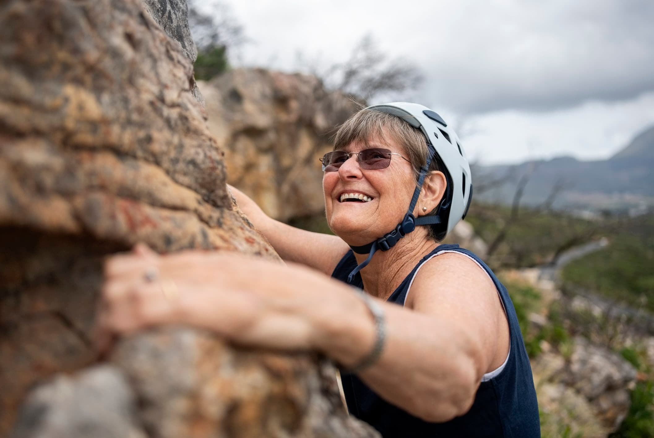 Older woman rock climbing
