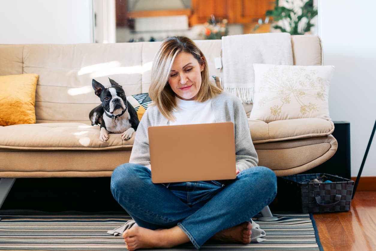 woman sitting on floor looking at computer